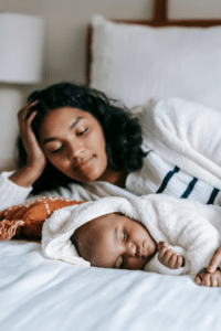 Infant sleeps in front of her mother