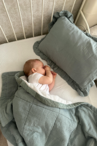 Infant sleeps peacefully in cot